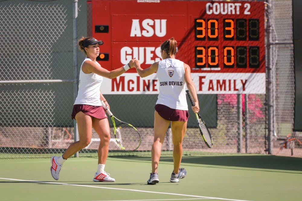 Seniors&nbsp;Desirae Krawczyk and Stephanie Vlad celebrate the point with a fist bump during the matchup against the California Bears on Friday, March 4, 2016 at the Whiteman Tennis Center in Tempe, Ariz. The two won their doubles set.