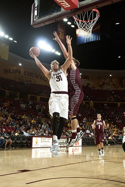 Senior forward Jonathan Gilling successfully scores despite a foul. ASU narrowly defeated Colgate, 78-71, at Wells Fargo Arena on Saturday, Nov. 29, 2014. (Photo by Mario Mendez)