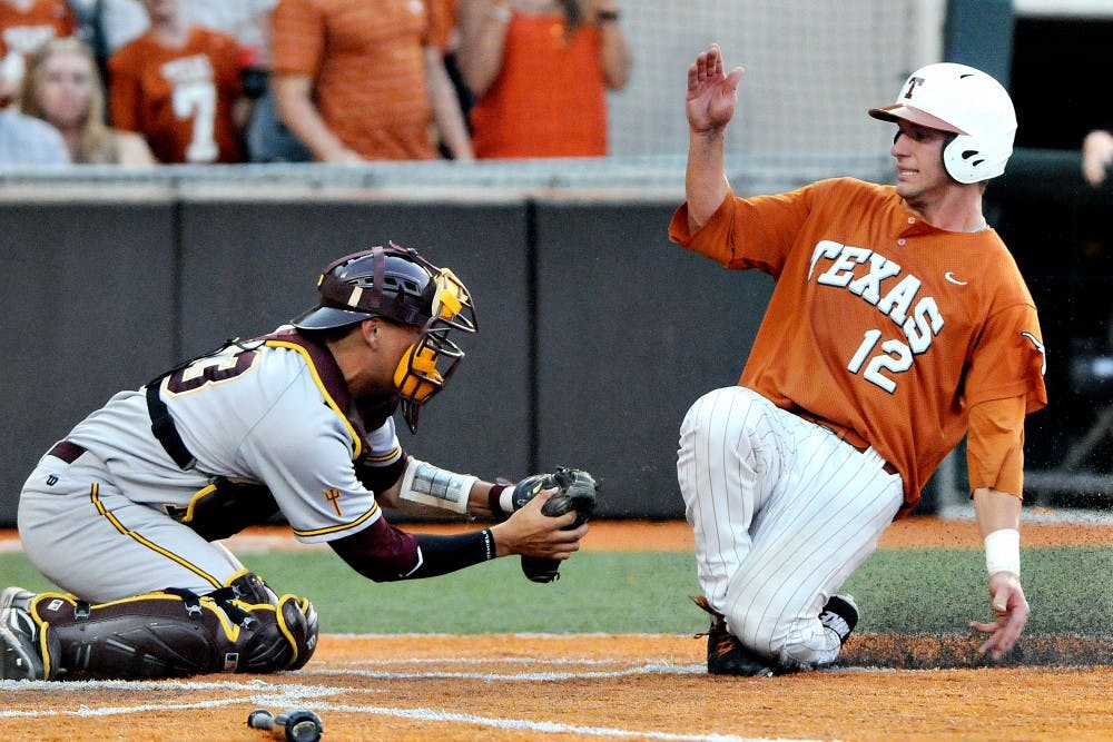 ASU senior catcher Xorge Carrillo makes the tag at home on Texas freshman Jacob Felts during the Sun Devils' 5-1 loss to the Longhorns on Saturday. The Sun Devils dropped a tough third game to Texas on Sunday, getting knocked out of the playoffs at the Super Regional stage. (Photo by Emilia Harris)