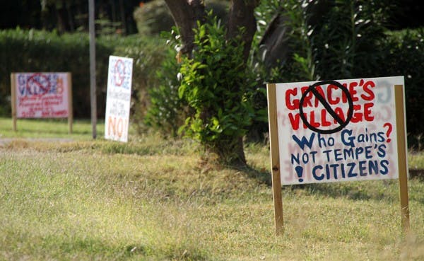 NOT HAPPY: Neighbors of Gracie’s thrift store express their opposition to the proposed building plans with scattered yard signs. (Photo by Rosie Gochnour)