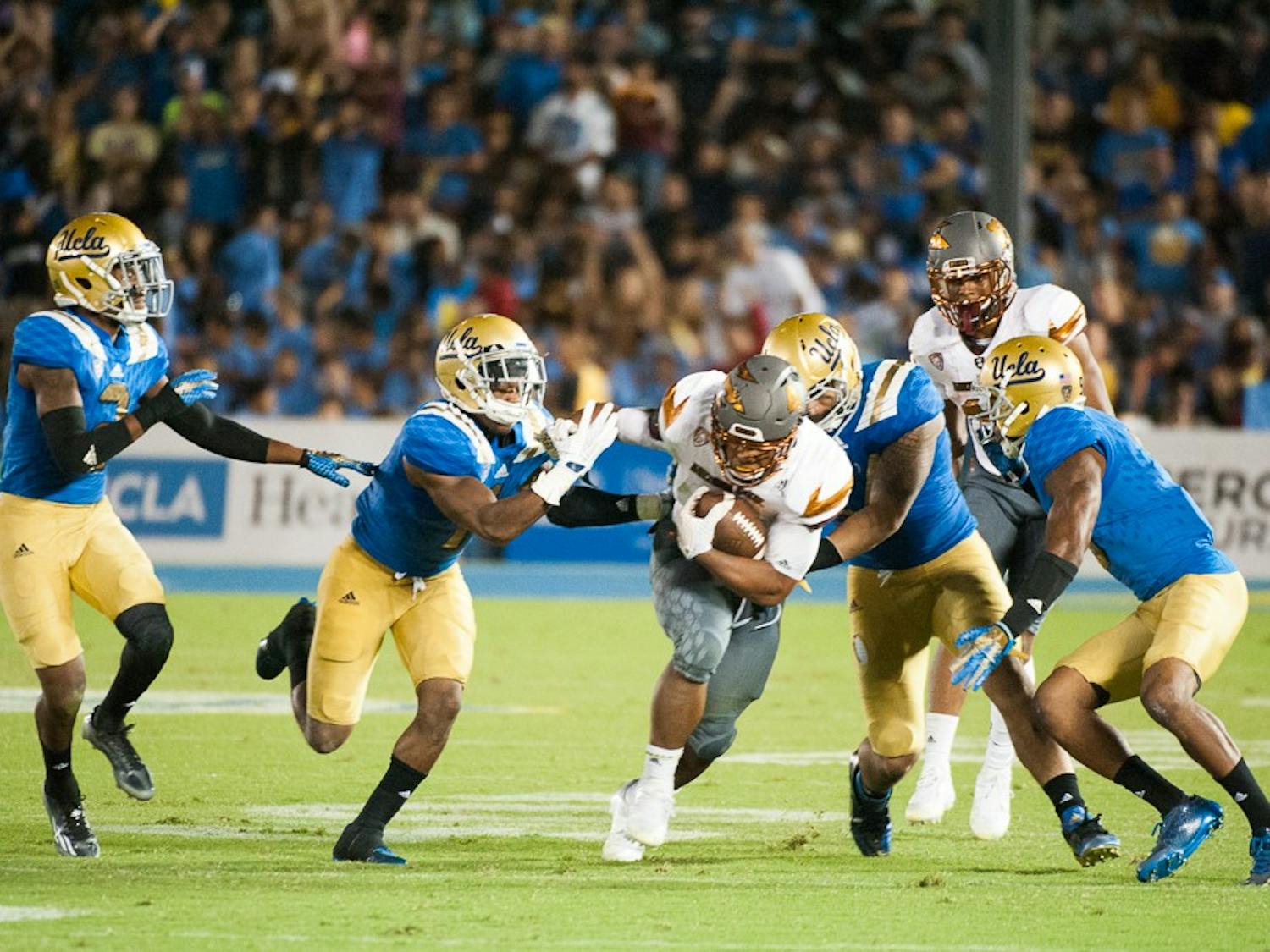 Sophomore running back Demario Richard (4) tries to escape UCLA tacklers on Saturday, Oct. 3, 2015, at Rose Bowl Stadium in Pasadena, Calif. The Sun Devils defeated the Bruins 38-23.