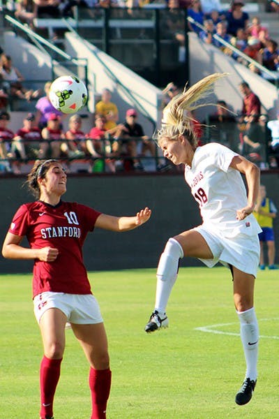 Redshirt junior forward Mackenzie Semerad heads the ball against a Stanford defender in a home game on Sunday, Oct. 26, 2014. Stanford won the game 2-0. (Photo by Sawyer Hardebeck)