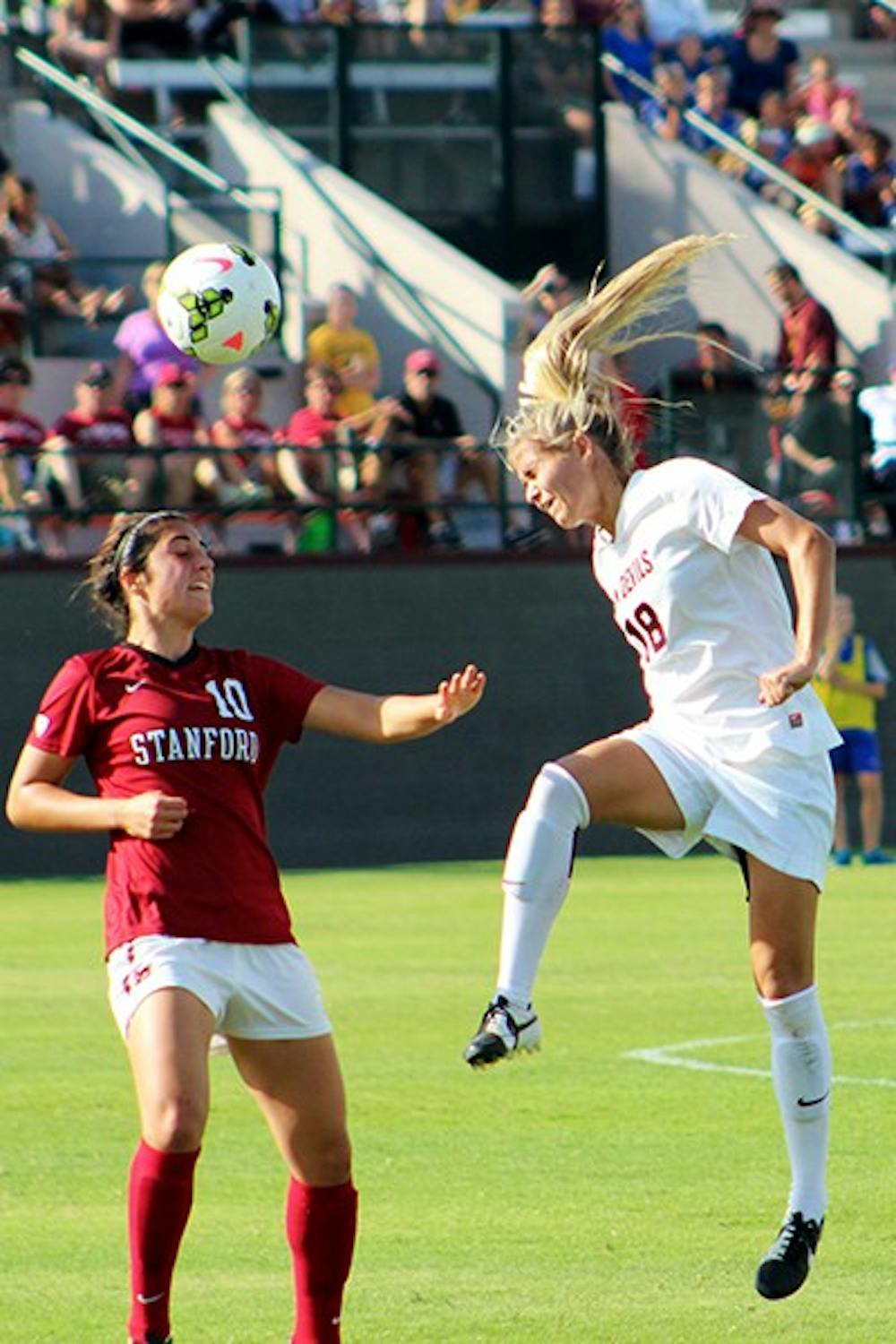 Redshirt junior forward Mackenzie Semerad heads the ball against a Stanford defender in a home game on Sunday, Oct. 26, 2014. Stanford won the game 2-0. (Photo by Sawyer Hardebeck)