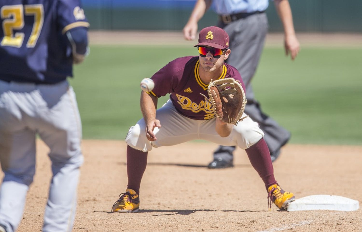 ASU baseball's David Greer catches a ball and forces out runner Davin Pearson during a game against California at Phoenix Municipal Stadium in Phoenix, Arizona, on Saturday, April 16, 2016. 