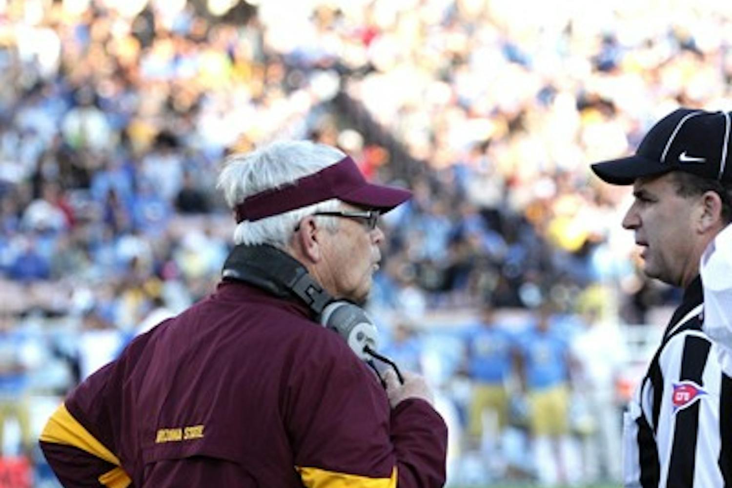 TAKING BLAME: ASU coach Dennis Erickson argues with a referee during the second quarter of the Sun Devils’ loss to UCLA on Saturday. Erickson took some of the blame for the defeat with clock mismanagement in the fourth quarter. (Photo by Elijah Grasser)
