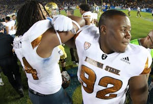 Redshirt junior defensive lineman Tramel Topps (92) celebrates with teammate Redshirt senior Demetrius Cherry (94) after the game against UCLA on Saturday, Oct. 3, 2015, at Rose Bowl in Pasadena, California. The Sun Devils defeated the Bruins 38-23.