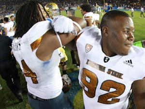 Redshirt junior defensive lineman Tramel Topps (92) celebrates with teammate Redshirt senior Demetrius Cherry (94) after the game against UCLA on Saturday, Oct. 3, 2015, at Rose Bowl in Pasadena, California. The Sun Devils defeated the Bruins 38-23.