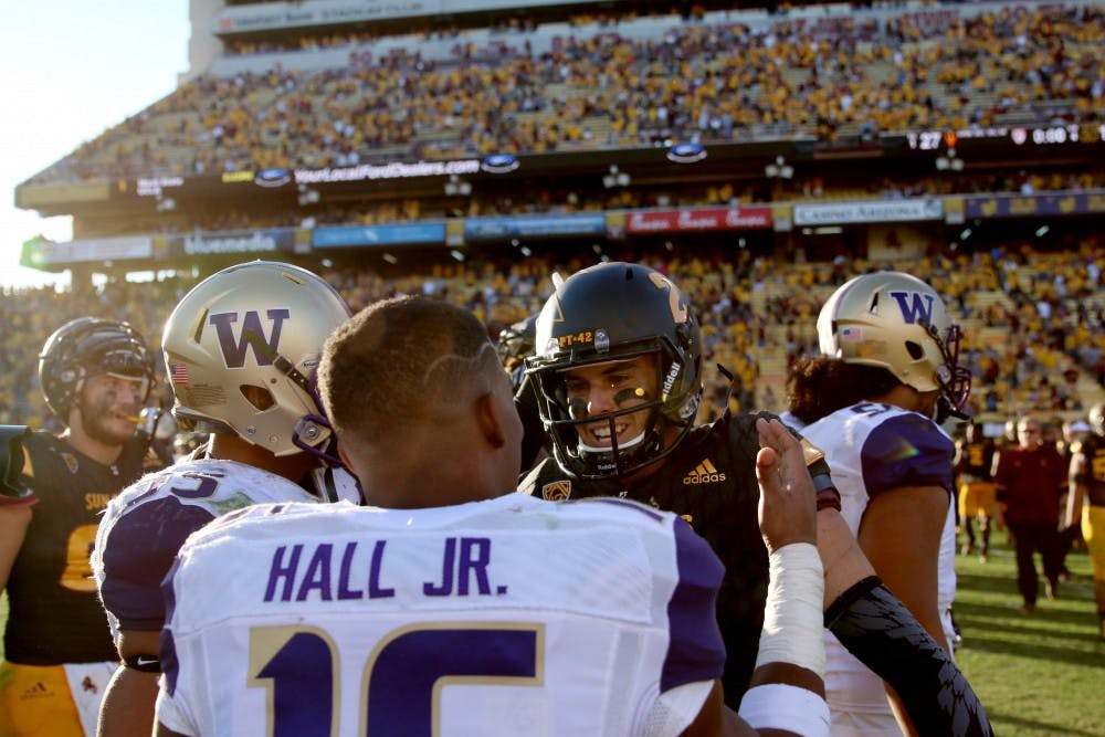 ASU redshirt senior quarterback Mike Bercovici greets Washington senior receiver Marvin Hall after the Sun Devils defeated the Huskies 27-17 at Sun Devil Stadium on Nov. 14, 2015.