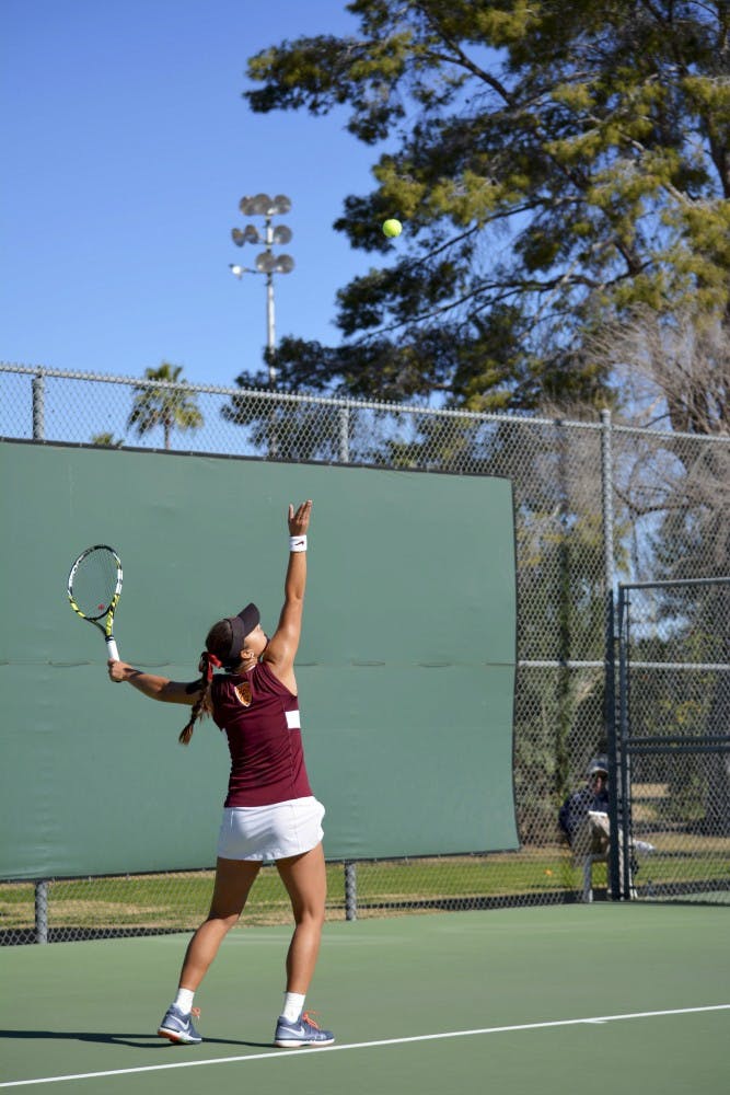 Junior Desirae Krawczyk serves to UC Davis doubles partners on Saturday, Jan. 15, 2015, at Whiteman Tennis Center in Tempe. The match was abandoned due to a 4-3 ASU lead in doubles match. (Krista Tillman/ The State Press)