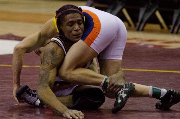 WRAP UP: Redshirt senior Anthony Robles wraps up Cal State Fullerton senior Andre Gonzalez during ASU's 25-19 victory over the Titans on Nov. 27. Robles, the No. 3 ranked wrestler at 125 pounds, will compete with his teammates against the nations top teams at the Las Vegas Invitational this weekend. (Photo by Aaron Lavinksy)
