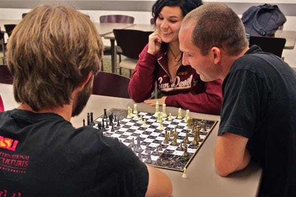 INTERNATIONAL PLAY: Four students play four-sided chess Tuesday night at International Game Night at the Memorial Union. The event is part of International Education Week, taking part all over the U.S., informing students about the opportunities available in study abroad. (Photo by Rosie Gochnour)