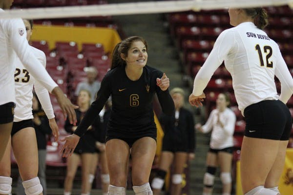 Junior libero Stephanie Preach (6) celebrates with freshman outside hitter Macey Gardner (12) after a play during the ASU Sheraton Invitational on Sept. 15. (Photo by Kyle Newman)