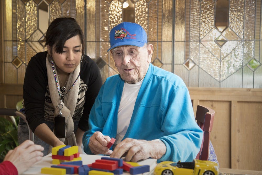 A caretaker helps a patient at Hospice of the Valley on Feb. 6, 2014. Hospice of the Valley and ASU recently created a partnership to form a class for students to act as caretakers to Alzheimer’s patients