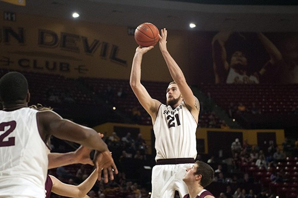 Junior forward Eric Jacobsen clears a jump shot. ASU narrowly defeated Colgate, 78-71, at Wells Fargo Arena on Saturday, Nov. 29, 2014. (Photo by Mario Mendez)