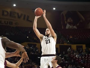 Junior forward Eric Jacobsen clears a jump shot. ASU narrowly defeated Colgate, 78-71, at Wells Fargo Arena on Saturday, Nov. 29, 2014. (Photo by Mario Mendez)