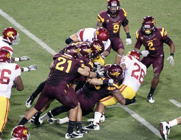 GOING NOWHERE: USC redshirt freshman wide receiver Kyle Prater gets tackled by a group of Sun Devils during ASU’s victory on Saturday. The Sun Devil defense forced four turnovers, including an interception for a touchdown. (Photo by Beth Easterbrook)