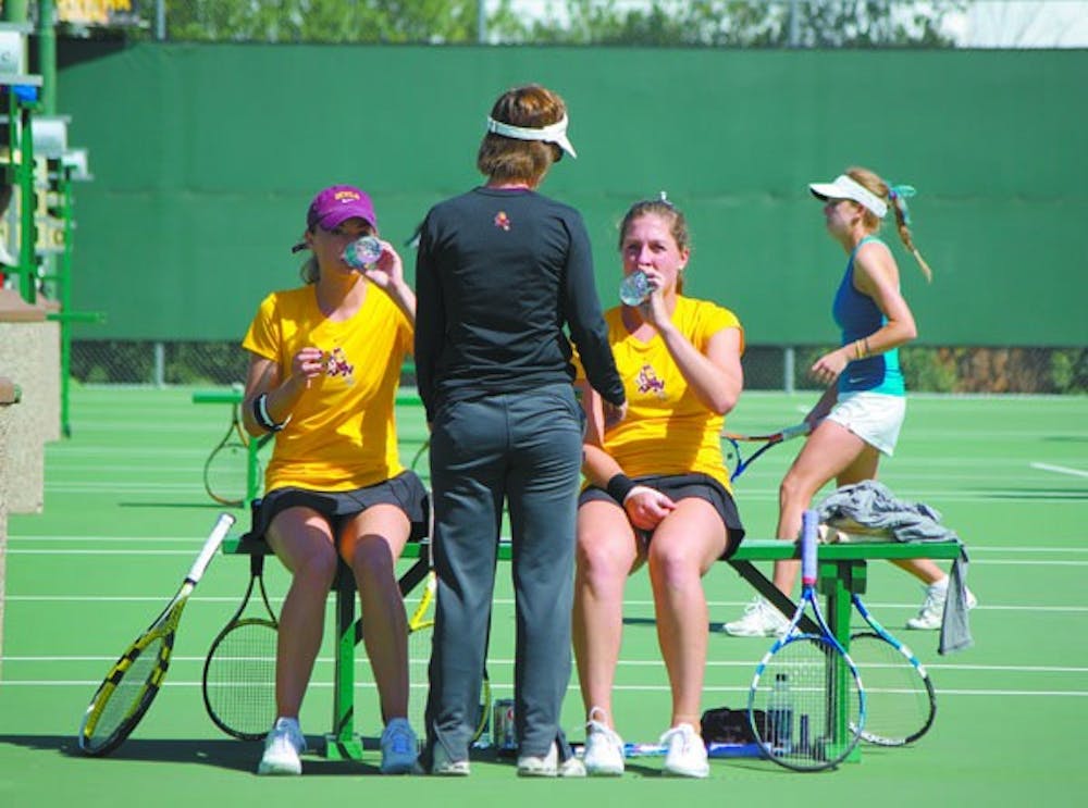 Sweeping up: ASU coach Sheila McInerney talks to seniors Micaela Hein (left) and Kelcy McKenna (right) during a break in their doubles match against UC Irvine on Tuesday. The Sun Devils beat both UC Irvine and DePaul on Wednesday by the same score, 7-0. (Photo by Nathan Meachem)