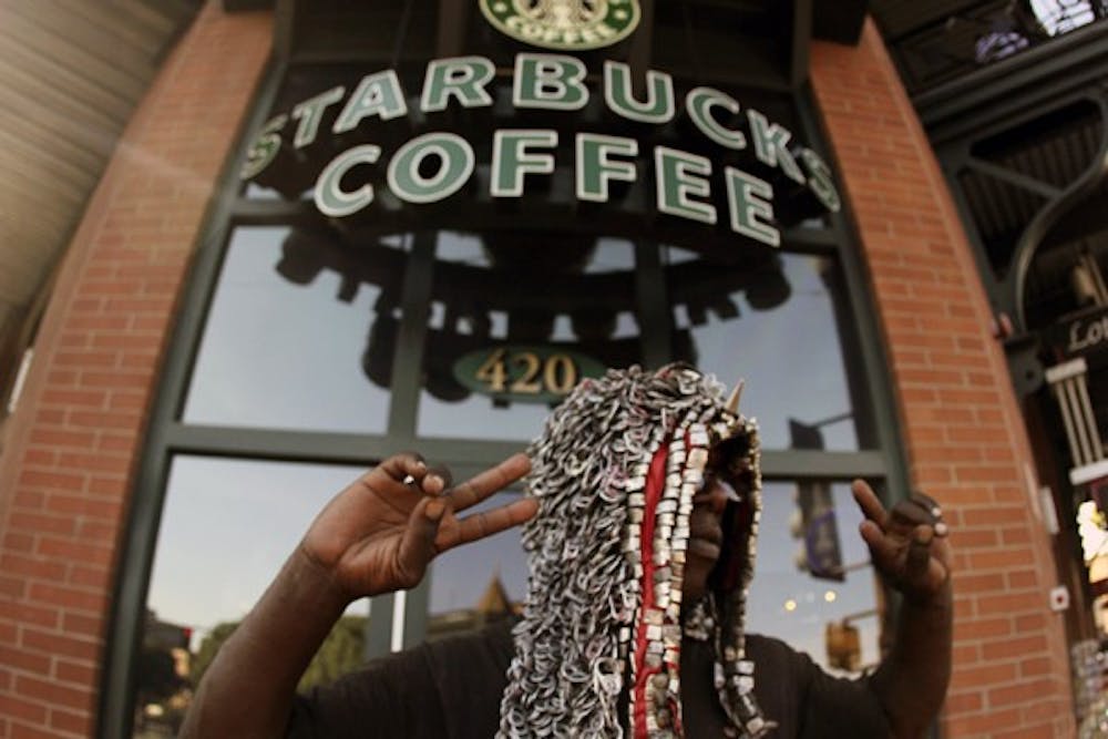 ON MILL: 'Chicago' stands outside Starbucks on Mill Avenue and bears the heat as he jokes with shoppers and welcomes them to Tempe. Tempe's Homeless Outreach Program Effort estimates the number of homeless people in Tempe to be between three and five hundred depending on the day. (Photo by Samuel Rosenbaum)