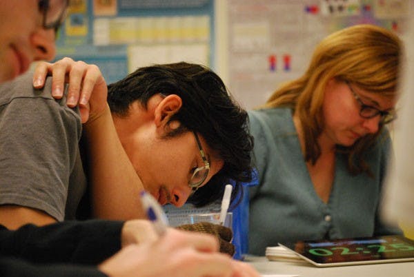Joey Eschrich (left), research and operations coordinator for the Center for Science and the Imagination, and Wesley de la Rosa (center), digital culture senior, quickly write down their "Green Dreams," in the five minute time constraint for the Green Dreams project in Wrigley Hall Wednesday afternoon. (Photo by Murphy Bannerman)