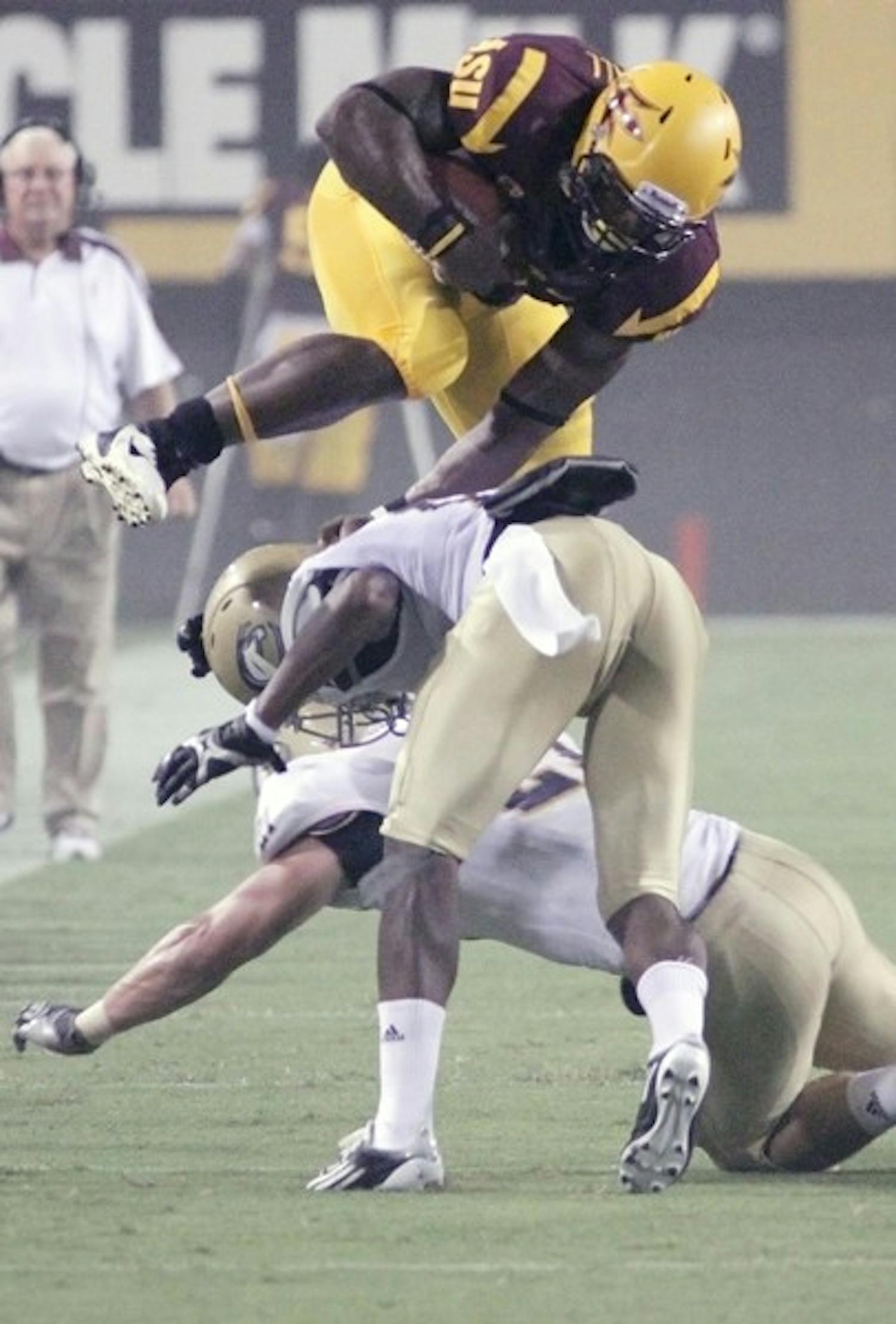 ON SPRINGS: ASU junior running back Cameron Marshall leaps over a pair of UC Davis defenders during the Sun Devils’ victory on Sept. 1. ASU is aiming to increase their tempo on offense against Mizzou. (Photo by Beth Easterbrook)