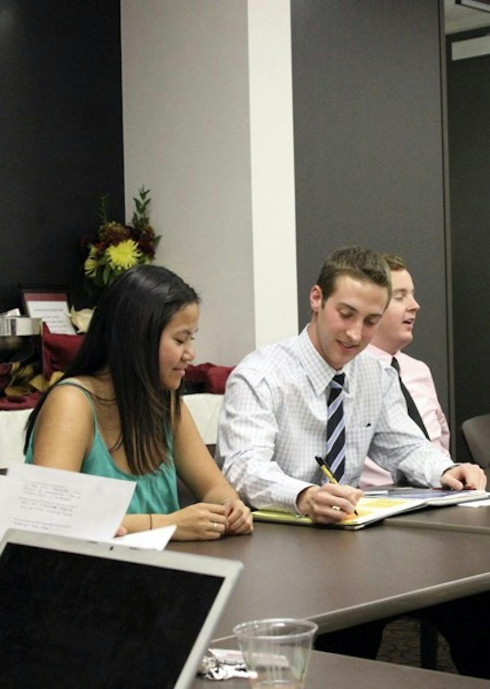 STUDENT LEADERS: Tina Mounlavongsy, USG President Jacob Goulding, and James Baumer address the senate at a USG meeting Tuesday evening to discuss several topics, including adding more emergency light boxes on campus as a preventative measure. (Photo by Sam Rosenbaum)