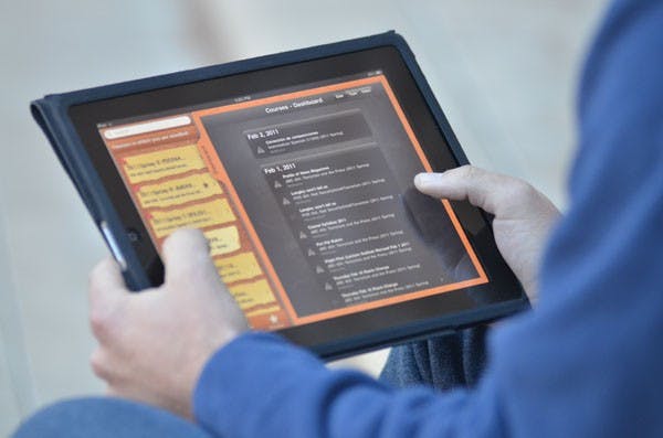 IPAD ACADEMICS: A student navigates the Blackboard application on an Apple iPad, one of the many educational tools available for mobile learning. The Downtown ASU Spanish Department has begun integrating the new technology into its classrooms, a move that is being met with mixed feelings. (Photo by Aaron Lavinsky)