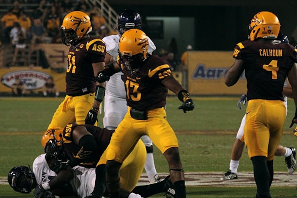 Freshman defensive back Armand Perry celebrates after stopping a run at a home game against Weber State on Aug. 28. ASU won against Weber State 45-14. (Photo by Alexis Macklin)