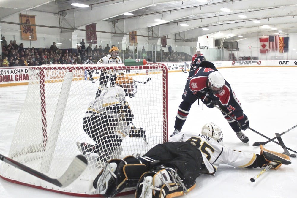 Sophomore goalie Robert Levin and defensemen Drew Newmeyer and Gianni Mangone defend their net from an Arizona attacker. The Sun Devils routed the Wildcats 7-0 on Jan. 30, 2015 at Ocean Side Arena in Tempe.