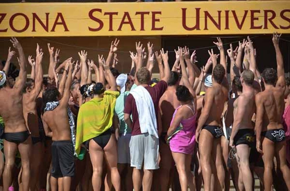 Hands Up: The ASU swim team joins together after a meet earlier this season. The swim team has experienced a rougher start to the season than the dive team due to a large number of freshman on the roster. (Photo by Aaron Lavinsky)