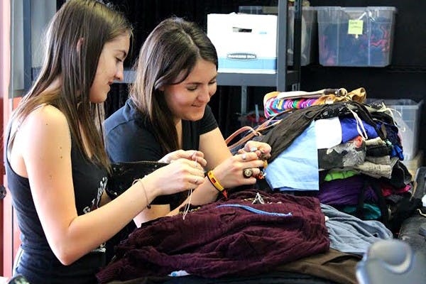 GlobeMed members Audrey Day (right) and Sophia McGovern (left) raised $124 at Name Brand Exchange by selling clothes that were donated in order to support a beneficiary family in Uganda by building a brick house, pit latrine and water tank. (Photo by Brittany Schmus)