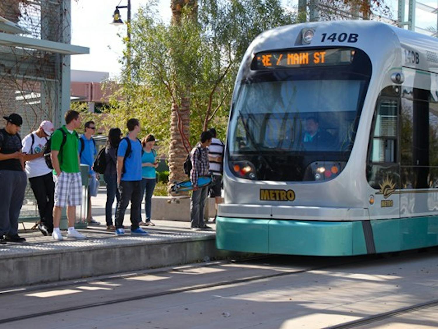 ALL ABOARD: Students prepare to board the light rail at the ASU Tempe Campus stop at Rural Road and University Drive. (Photo by Rosie Gochnour)