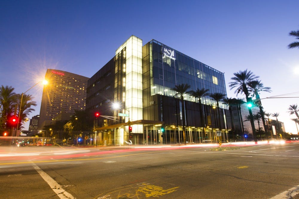 Vehicles pass in front of the ASU College of Nursing and Health Innovation in downtown Phoenix, Arizona, on Monday, Nov. 8, 2015.