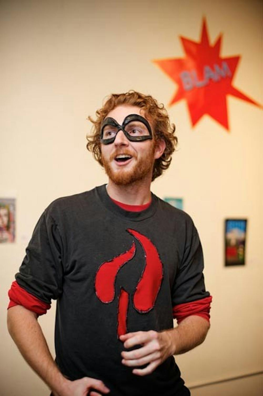 BLAM!: Anthony Kneale, a senior theater major, gets into character to explain his comic book art during Amazing Ink, an art show for comic book artists on the Tempe campus. (Photo by Michael Arellano)