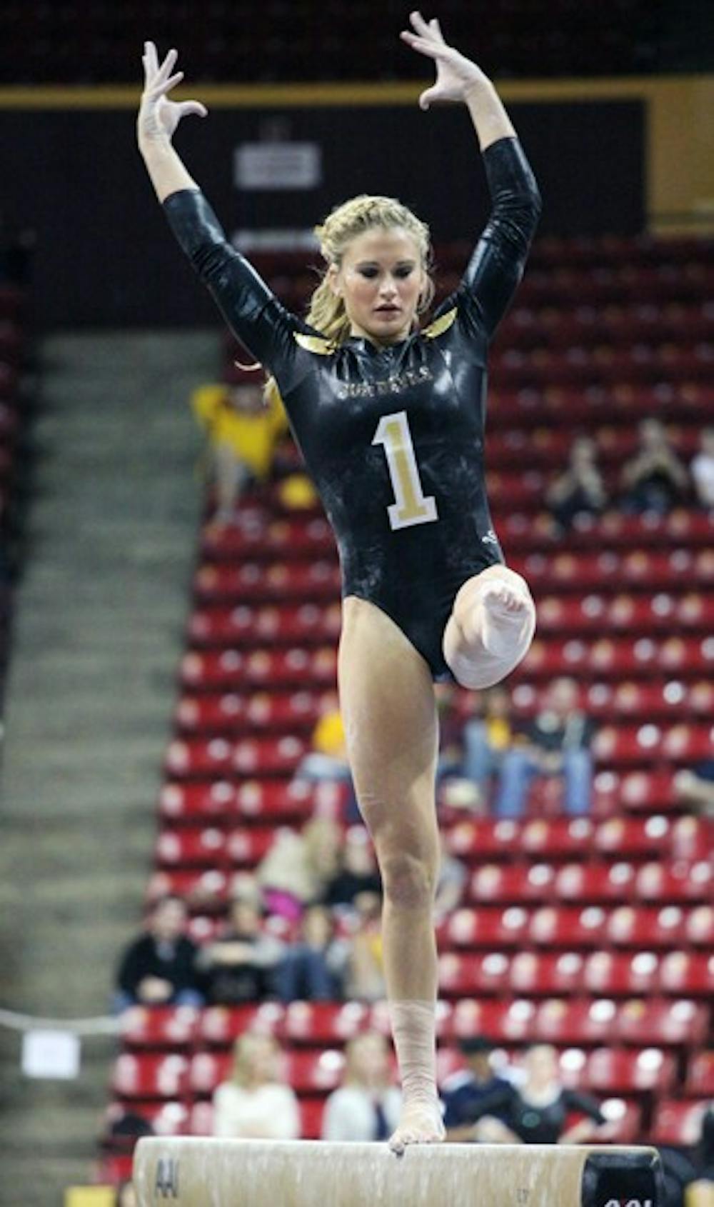 Senior Madison Snowden performs on the beam in a meet against UA on Jan. 27. The Gym Devils defeated the Wildcats for the first time since 2006. (Photo by Beth Easterbrook)