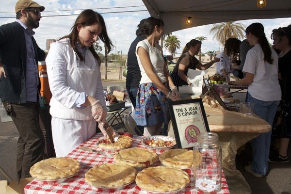 PIE EXTRAVAGANZA: Laura Godfrey with Honey Moon Sweets Bakery and Desert Bar serves up some Apple Cranberry and Ginger Pie at the Pie Social, presented by Chow Bella and Roosevelt Row, on Saturday in downtown Phoenix. (Photo by Shawn Raymundo)
