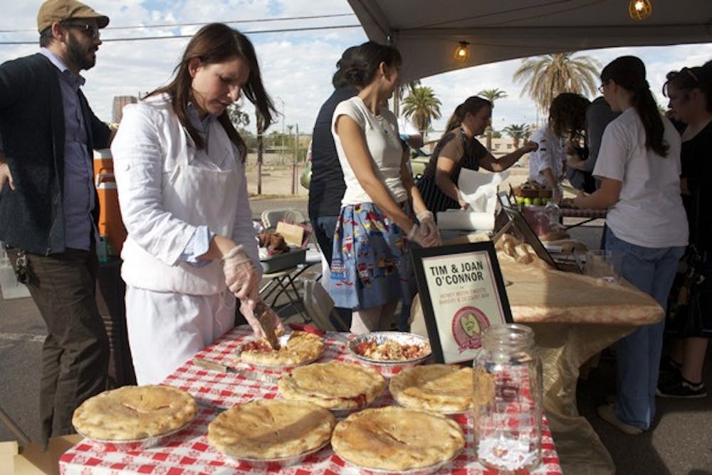 PIE EXTRAVAGANZA: Laura Godfrey with Honey Moon Sweets Bakery and Desert Bar serves up some Apple Cranberry and Ginger Pie at the Pie Social, presented by Chow Bella and Roosevelt Row, on Saturday in downtown Phoenix. (Photo by Shawn Raymundo)