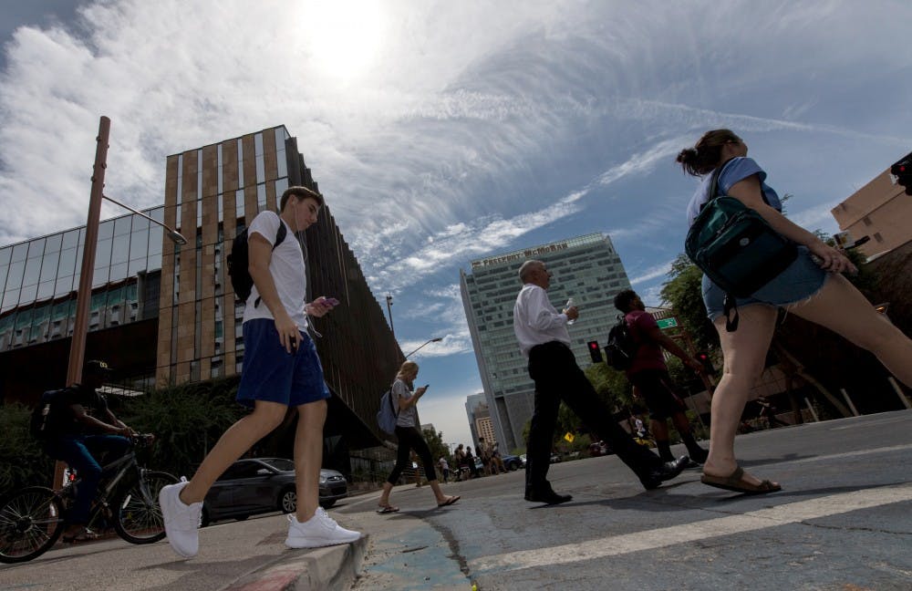 Pedestrians cross the street at the intersection of 1st and Taylor streets on the Downtown campus on Sept. 19, 2016.