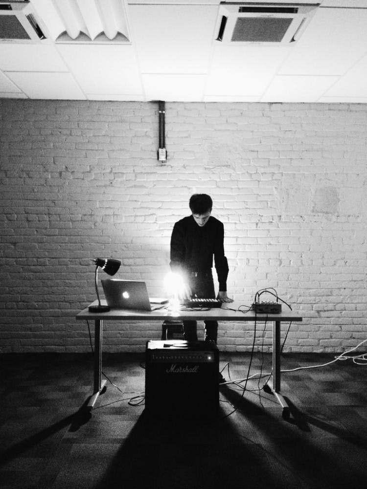 Tyler Griffin sets up his equipment before SPM Acoustics. 
Photo by Kelley Kleber