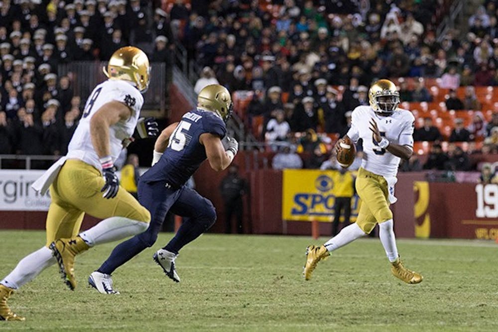 Notre Dame senior quarterback Everet Golson runs with the ball in a game against Navy on Nov. 1, 2014. (Photo Courtesy of The Observer/Photo by Jodi Lo)