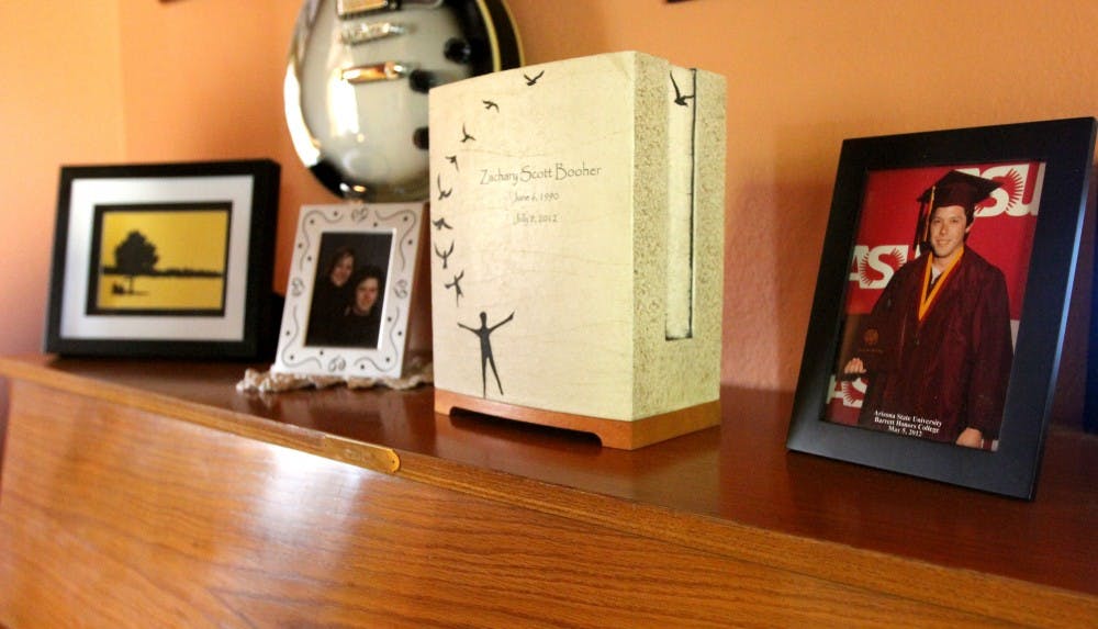 A piano in the Booher household holds photos and Zach's ashes. (photo by Yvonne Gonzalez)