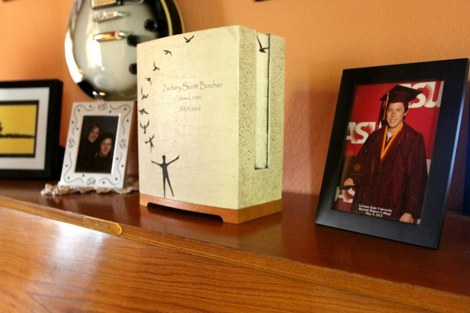 A piano in the Booher household holds photos and Zach's ashes. (photo by Yvonne Gonzalez)