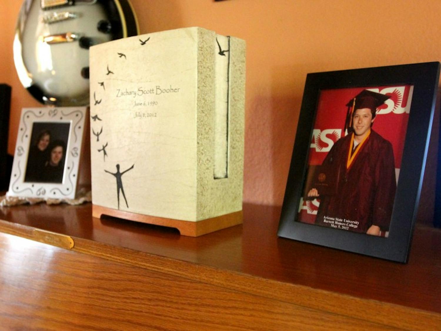 A piano in the Booher household holds photos and Zach's ashes. (photo by Yvonne Gonzalez)