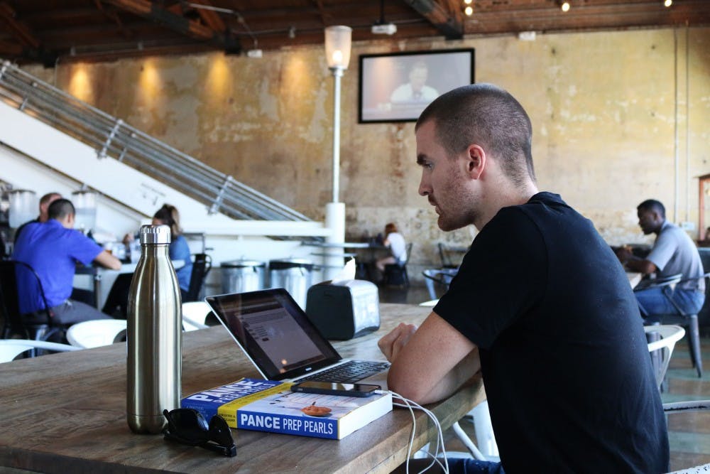 Nick Davis, a recent graduate from ASU, studies for his boards test at Desoto Central Market on Aug. 31, 2016.