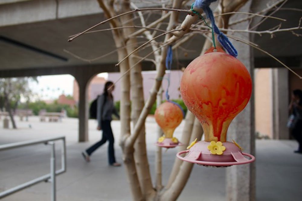 QUAFFLE STOMPED: Members of the ASU quidditch club get physical on Saturday during a half-time scrimmage at the Sun Devil women's basketball game. (Photo by Aaron Lavinsky)