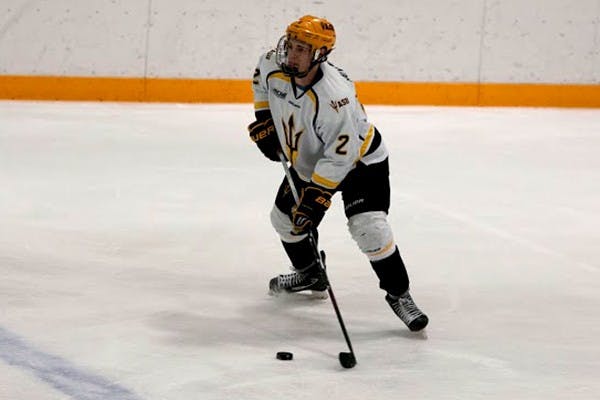  Freshman defender Drew Newmeyer skates with the puck at a home game. (Photo by Mario Mendez)