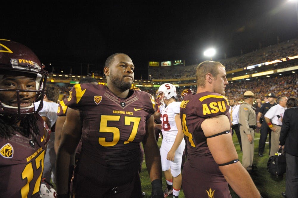 Redshirt freshman receiver Ronald Lewis (left) and redshirt sophomore left tackle Evan Goodman leave the field after the ASU game against Stanford, Saturday, Oct. 18, 2014, at Sun Devil Stadium in Tempe. The Sun Devils beat the Cardinals, 26-10.