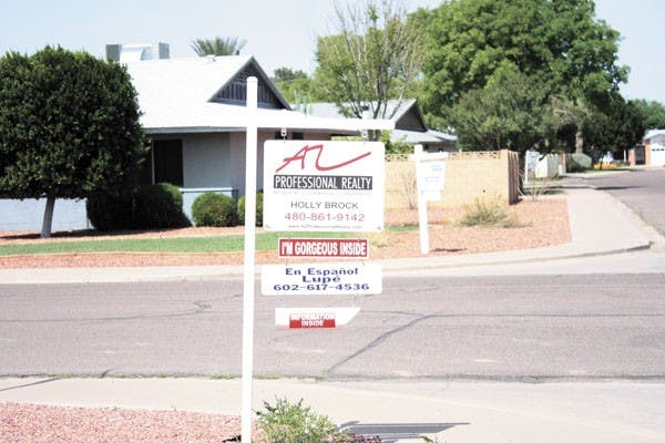 UP FOR GRABS: Three houses in a row, all up for sale. Right now in Tempe, there are many for sale and foreclosed houses. (Photo by Jessica Weisel)