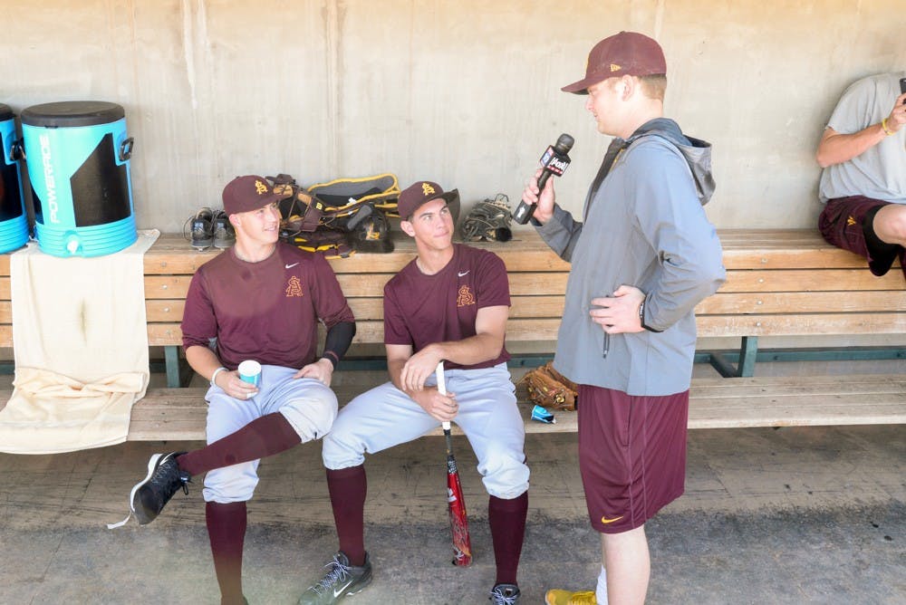 ASU pitcher Ryan Burr traded his ball glove for a microphone during ASU Media Day on Feb. 11, 2015, at the Phoenix Municipal Stadium. He conducted interviews throughout the afternoon and is seen here with freshman outfielder Coltin Gerhart, left, and freshman shortstop Colby Woodmansee (J. Bauer-Leffler/The State Press)