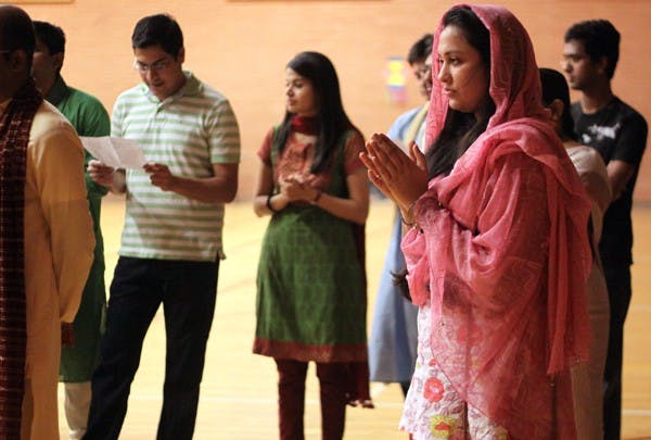 CELEBRATION: Gayatri Mahajan, a sophomore business law major, clasps her hands together during the Puja prayer that started off the evening celebrations. (Photo by Lillian Reid)