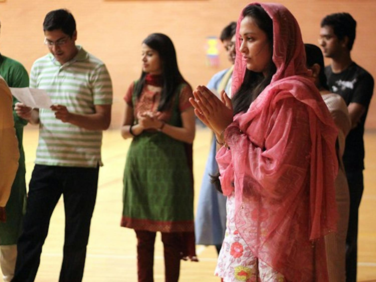 CELEBRATION: Gayatri Mahajan, a sophomore business law major, clasps her hands together during the Puja prayer that started off the evening celebrations. (Photo by Lillian Reid)